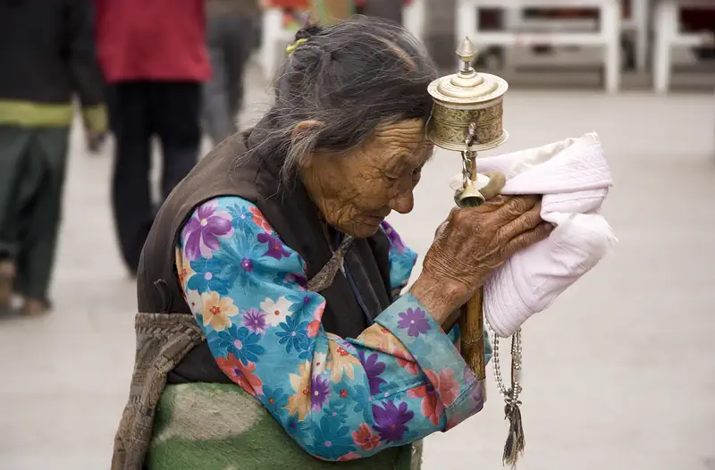 Barkhor Pilgrim Circuit: close-up of hands holding a prayer wheel and cloth