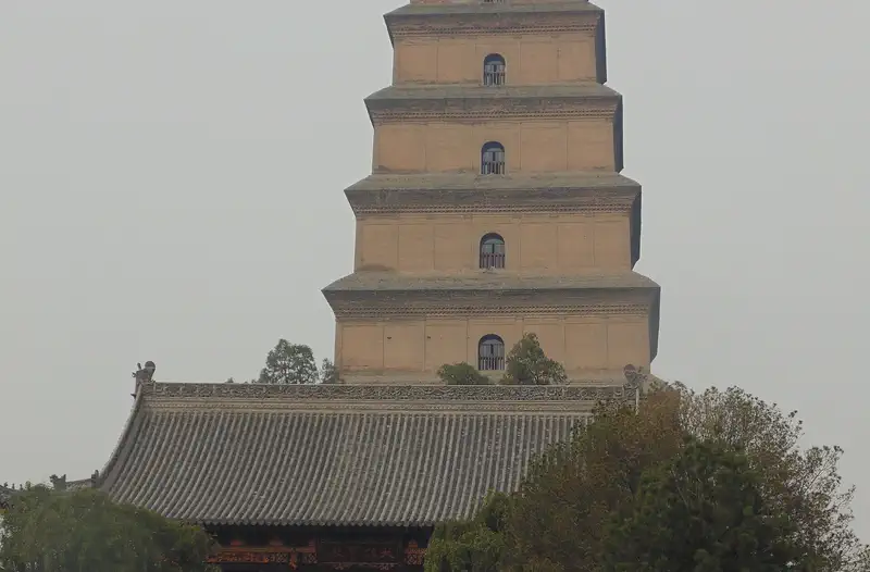 Big Wild Goose Pagoda: tiered brick tower rising above trees, with people at its base