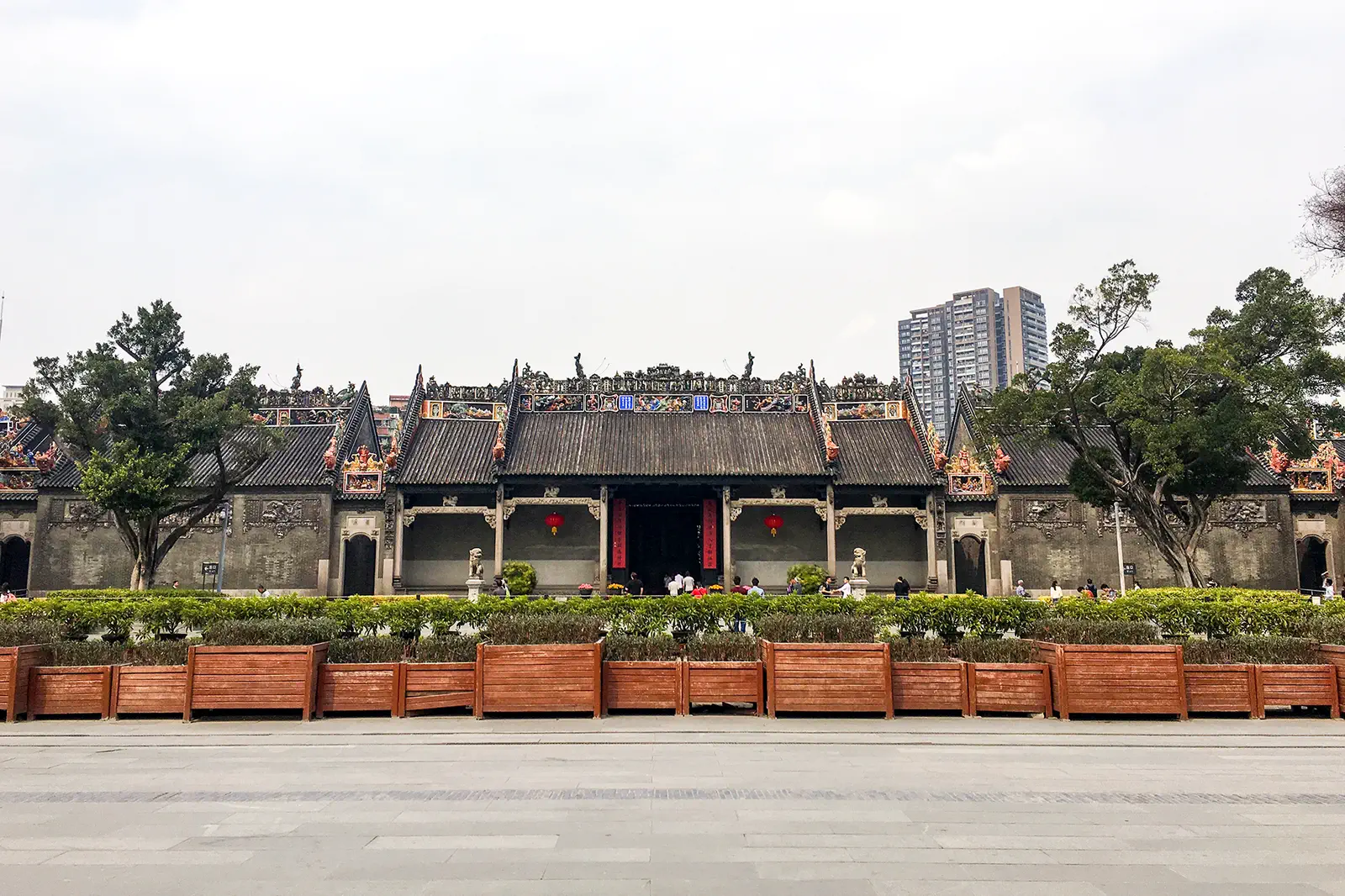 Chen Clan Ancestral Hall: the long grey-brick facade with ornate ridge decorations, seen across the forecourt