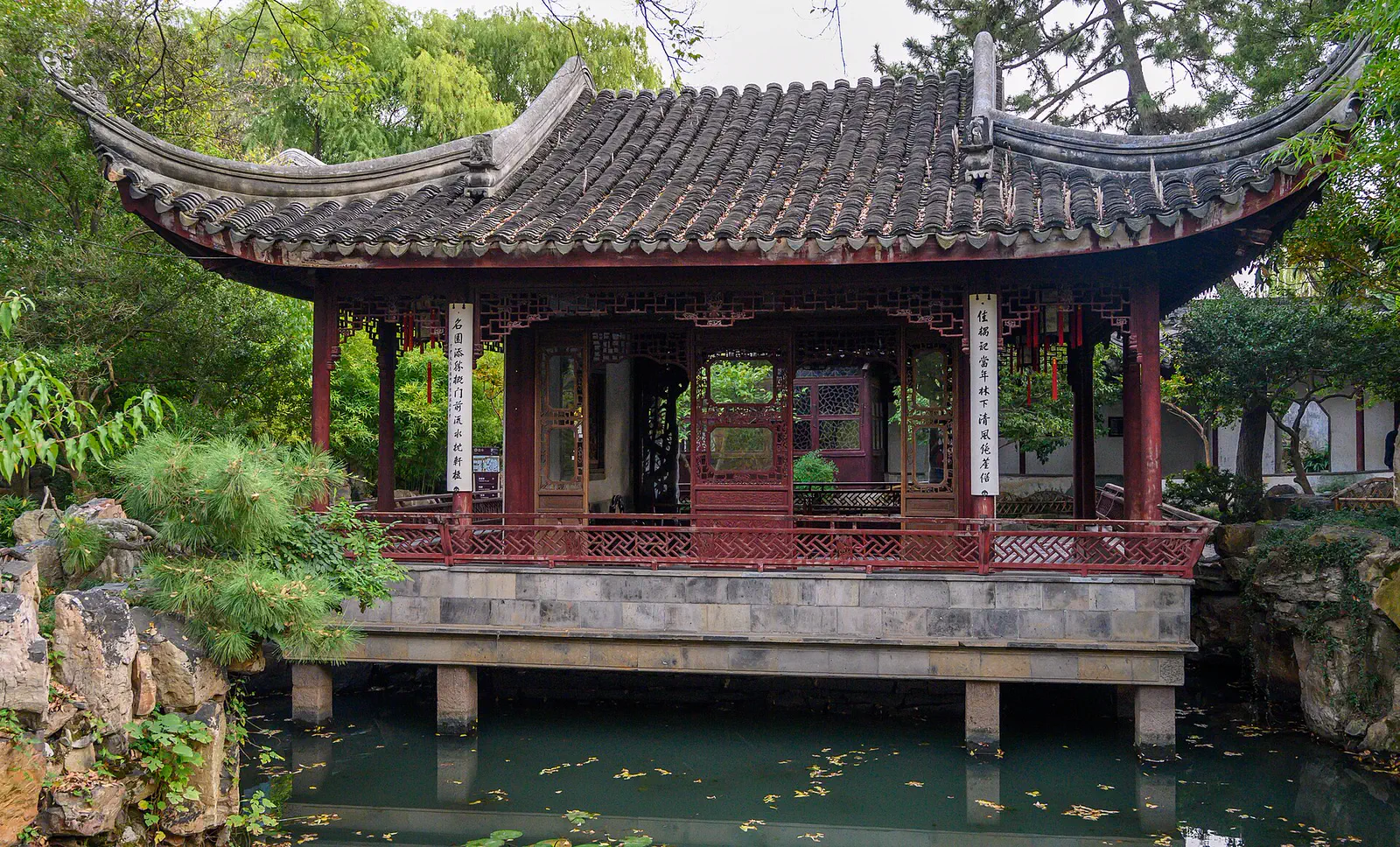 Couple's Retreat Garden: a red-columned waterside pavilion reflected in the garden pond