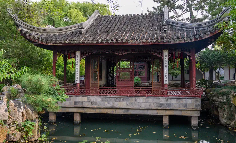 Couple's Retreat Garden: a red-columned waterside pavilion reflected in the garden pond