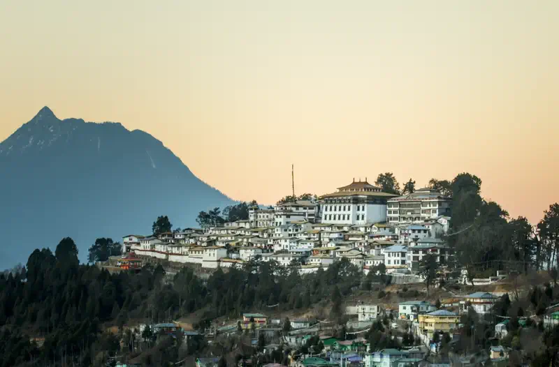 Drepung Monastery whitewashed monastic complex on hillside above Lhasa valley