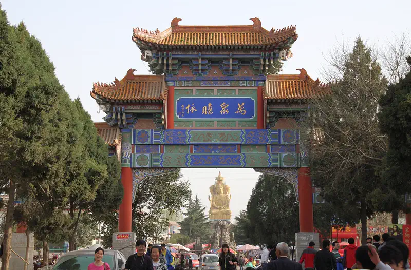 Famen Temple: ornate archway gate with a statue visible through the opening