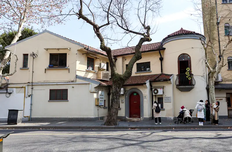 Former French Concession: a cream villa with a tiled roof behind a bare plane tree on Wukang Road