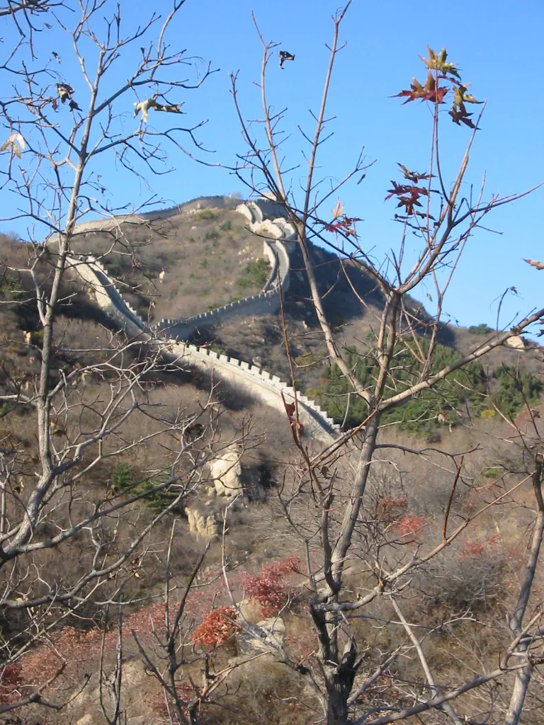 Great Wall: stone wall winding along a hillside ridge under blue sky