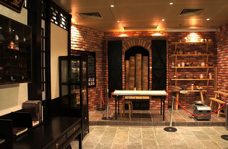 Hong Kong Museum of Art: interior room with a brick wall, wooden furniture and shelving