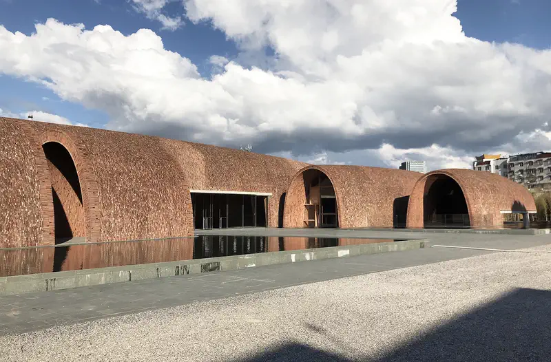 Jingdezhen Imperial Kiln Museum: long arched brick vaults beside a reflecting pool