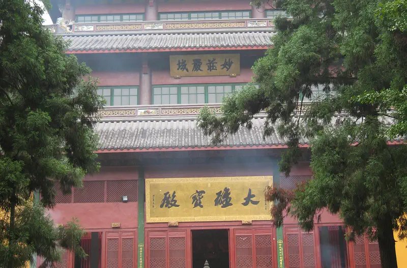 Lingyin Temple: red and gold temple facade with a crowd of visitors on the entrance steps