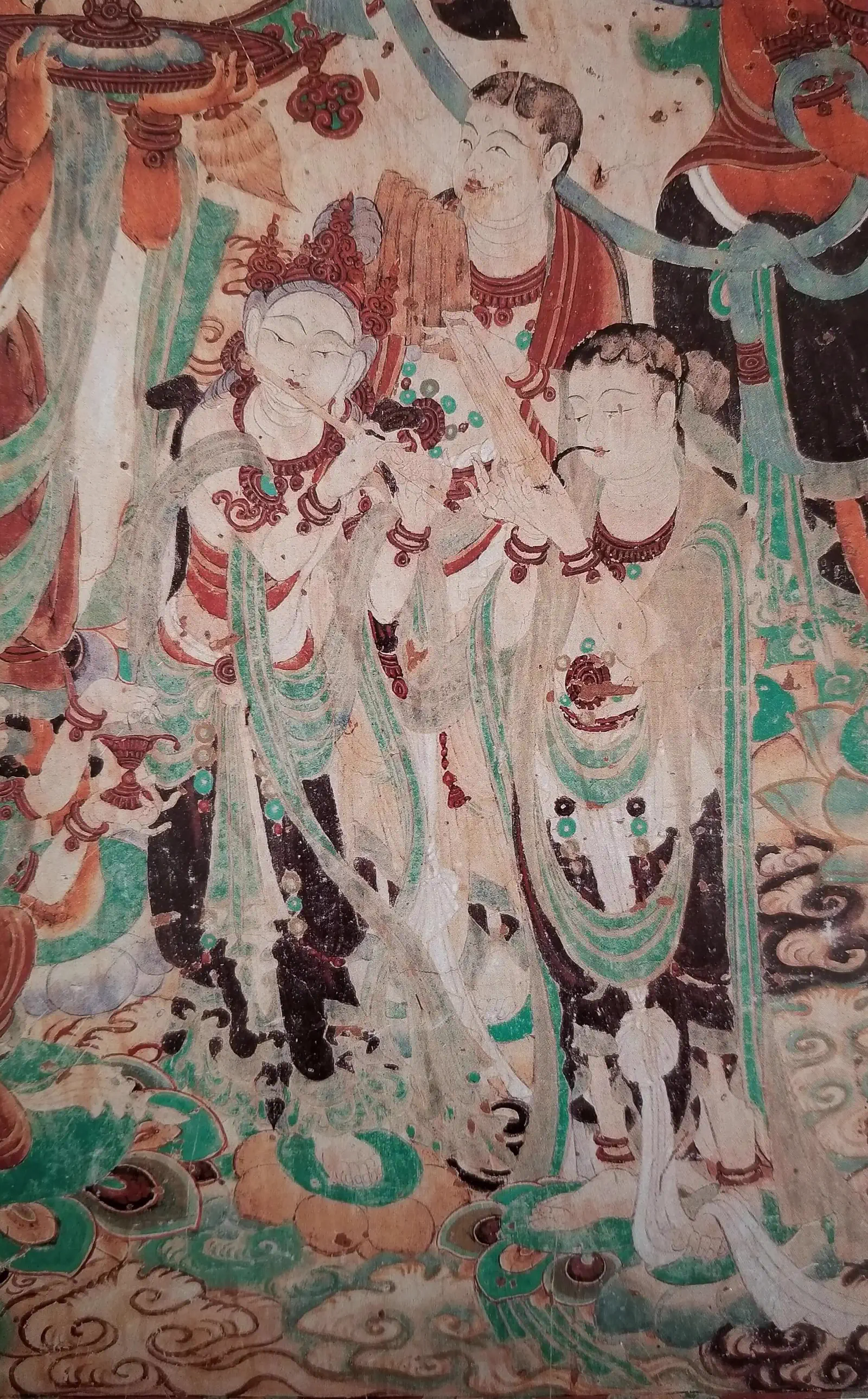 Mogao Caves: close-up of an ancient wall mural showing painted figures in red, green, and white pigments
