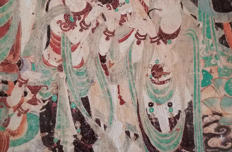 Mogao Caves: close-up of an ancient wall mural showing painted figures in red, green, and white pigments