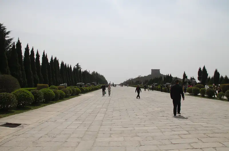 Qianling Mausoleum: the paved spirit way lined with conifers running toward the burial hills
