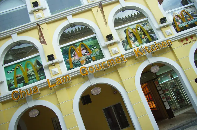 Senado Square: yellow colonial-style building facade with arched windows and shopfronts