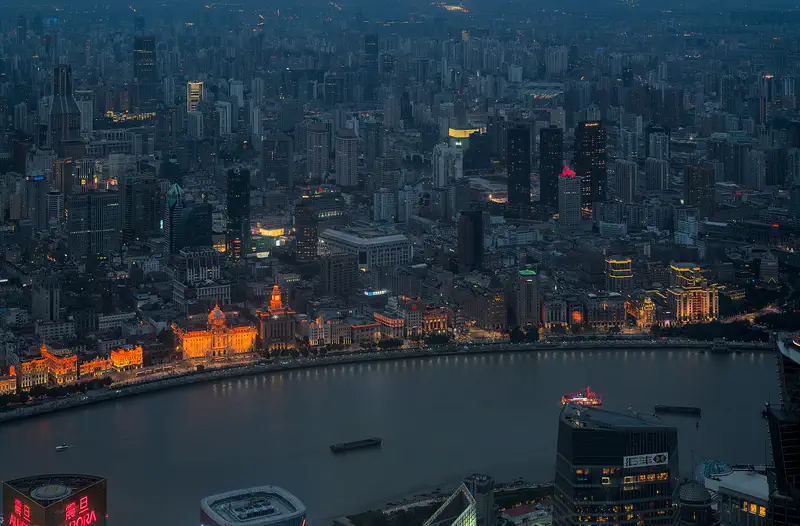 The Bund: the riverfront and city lights at blue hour, seen from a tower in Pudong