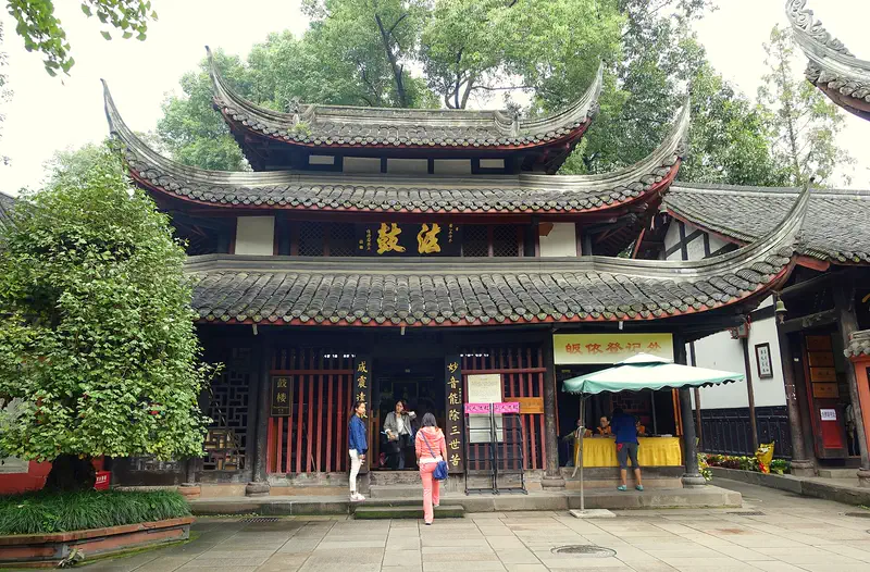 Wenshu Monastery: temple building with curved tiled eaves and a courtyard where visitors are walking
