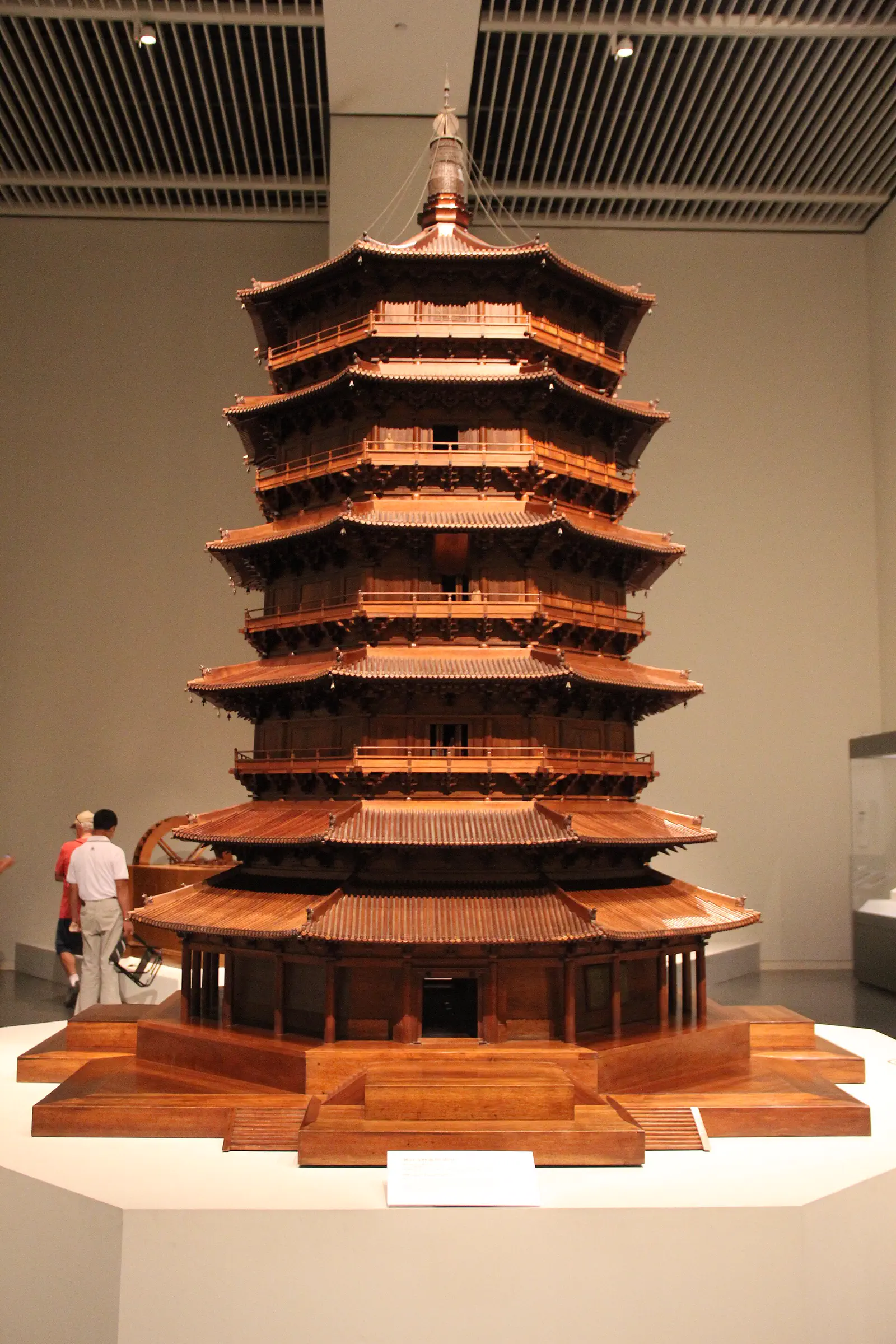 Wooden Pagoda of Yingxian: detailed wooden scale model of a multi-tiered pagoda displayed indoors beside a visitor