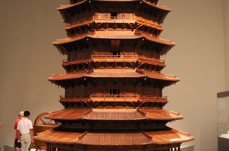 Wooden Pagoda of Yingxian: detailed wooden scale model of a multi-tiered pagoda displayed indoors beside a visitor