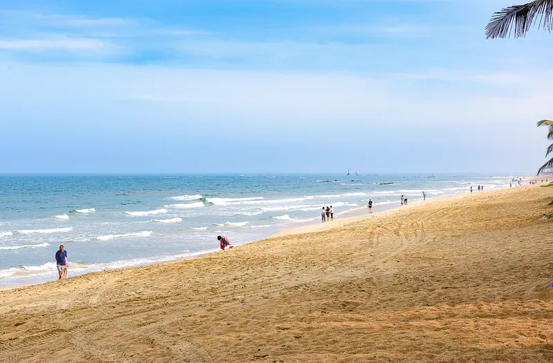 Boao: a wide empty beach on Hainan's east coast under a blue sky