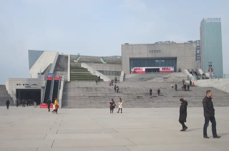 Changsha: modern building with wide stone steps and a plaza where people walk