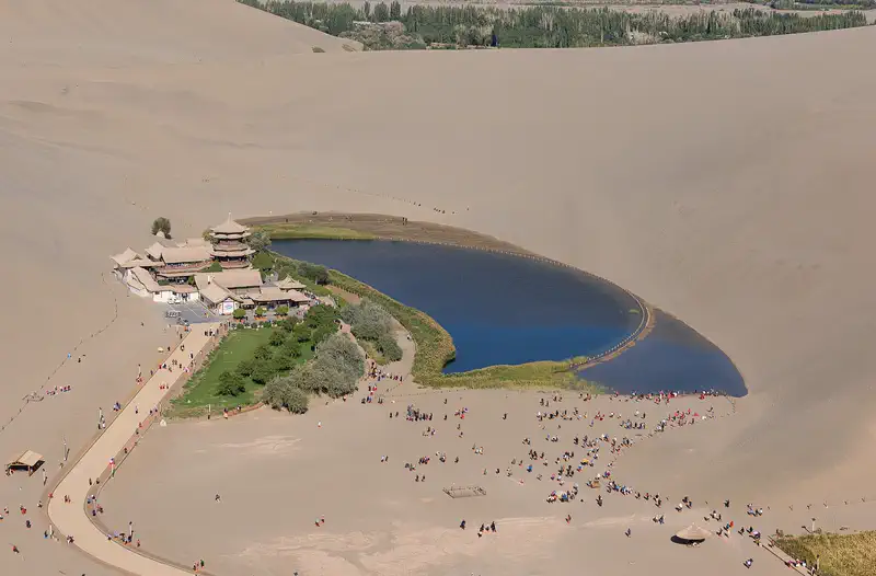 Dunhuang: the crescent-shaped lake and its pavilion enclosed by the Singing Sand Dunes