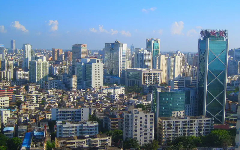 Haikou: city skyline with high-rise buildings under a clear blue sky