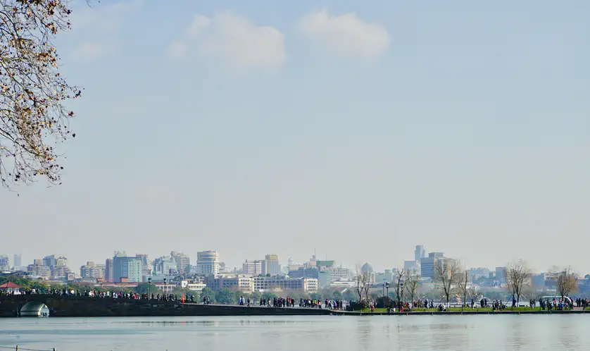 Hangzhou: lake with a distant city skyline visible under a cloudy sky