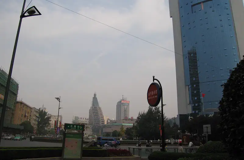 Hefei: city street with modern high-rise buildings under a hazy sky
