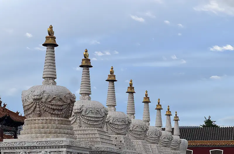 Hohhot: a row of white stupas at Dazhao Temple against a blue sky