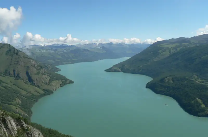 Kanas: the long turquoise lake winding between forested mountain slopes