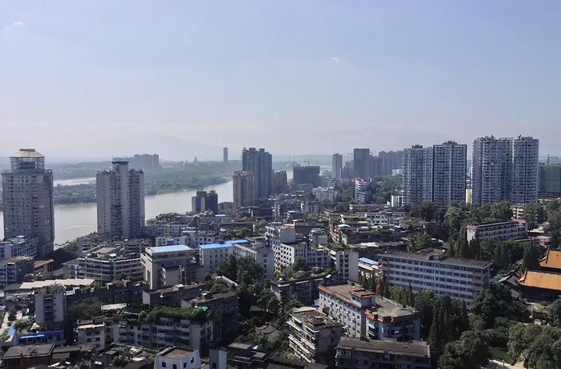 Leshan: aerial view of the city skyline along a wide river