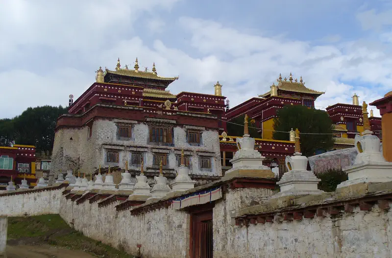 Litang: monastery complex with white and maroon buildings and small stupas