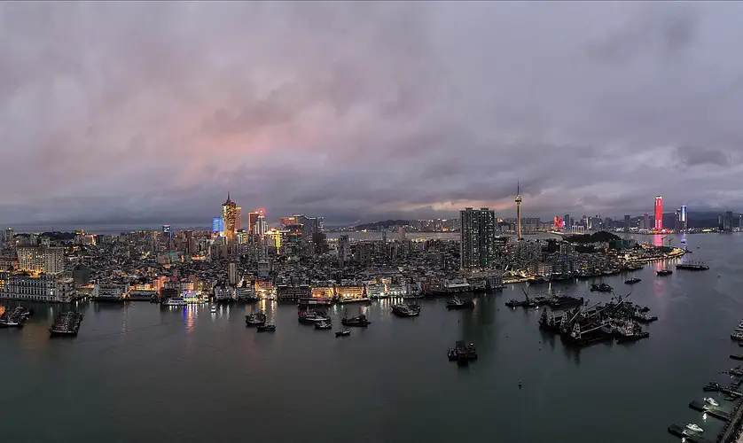 Macau: panorama of the west side of the Macau Peninsula across the water at dusk