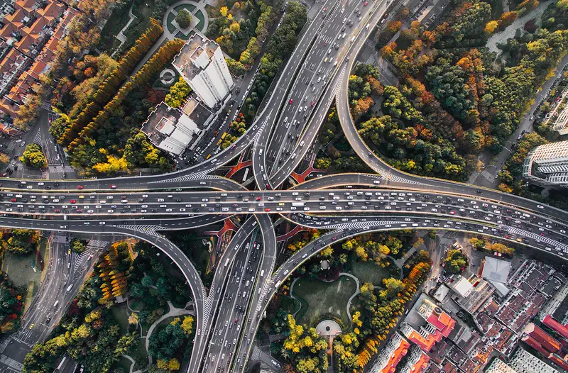 Shanghai: aerial view of the Yan'an East Road elevated interchange, ringed by trees in autumn colour