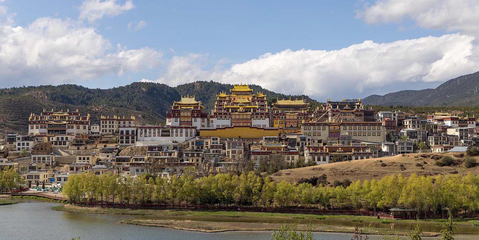 Shangri-La: the gold-roofed Ganden Sumtseling Monastery on its hillside above a lake