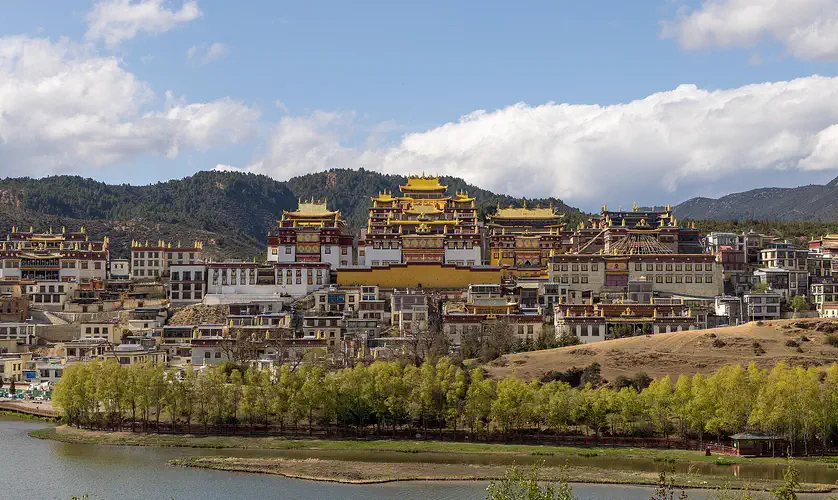 Shangri-La: the gold-roofed Ganden Sumtseling Monastery on its hillside above a lake