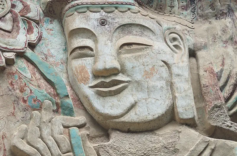 Tianshui: close-up of a weathered stone relief carving of a face