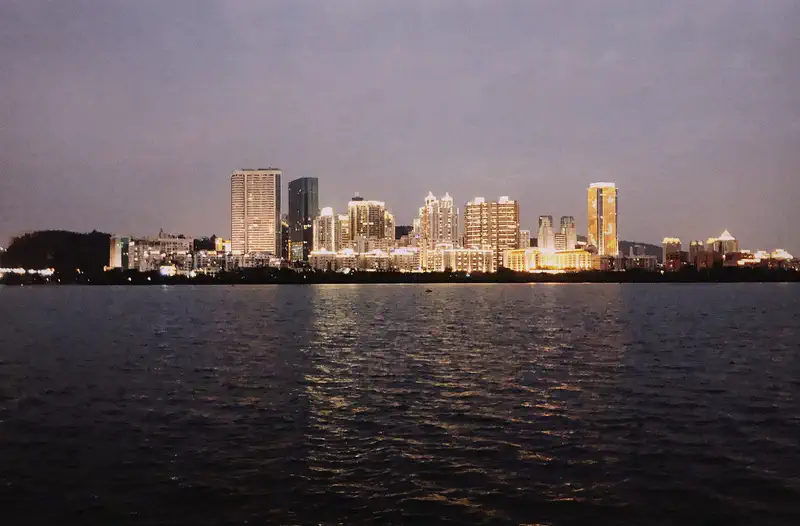 Xiamen: lit waterfront towers seen across the water in the evening