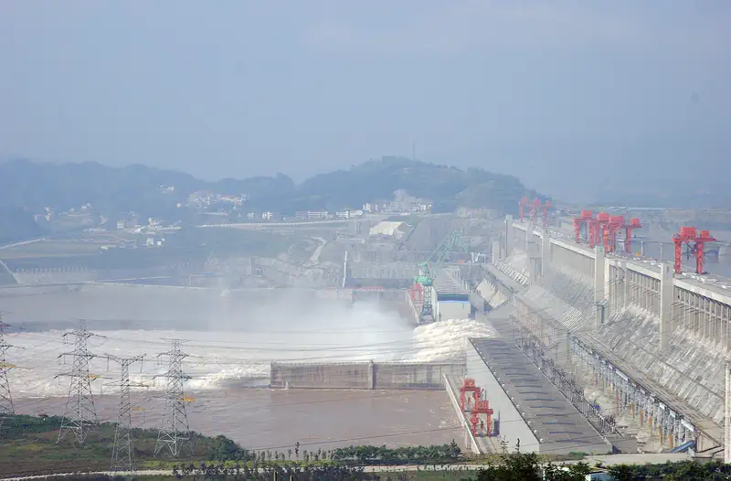 Yichang: the spillway section of the Three Gorges Dam with its gantry cranes, seen through haze