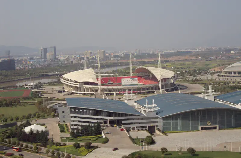 Yiwu: aerial view of a stadium and large buildings surrounded by greenery