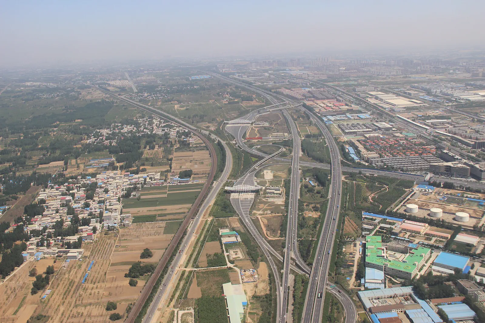 Zhengzhou: aerial view of highways and roads crossing farmland and buildings