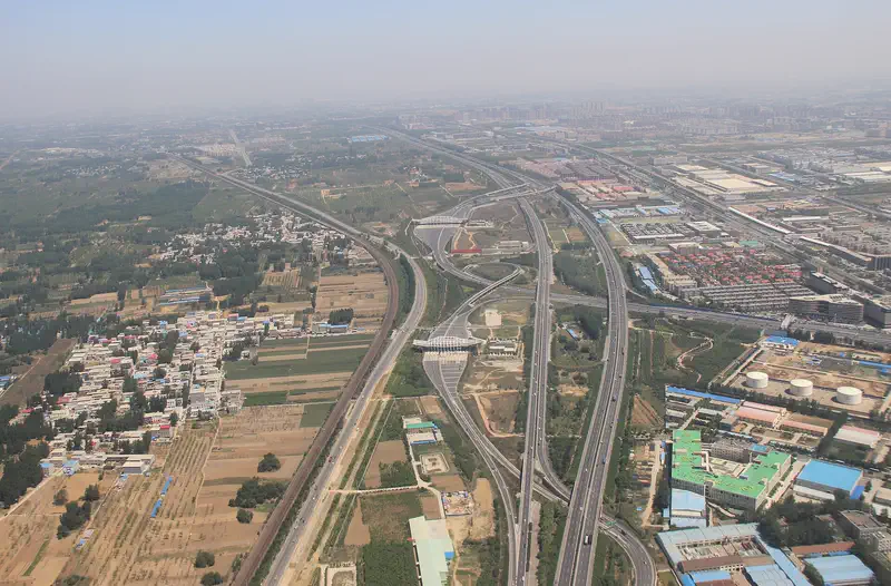 Zhengzhou: aerial view of highways and roads crossing farmland and buildings